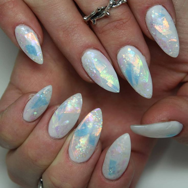 Elegantly Iridescent Stiletto Nail Design: Dreamy Blue and White Gem-Inspired Aesthetic.