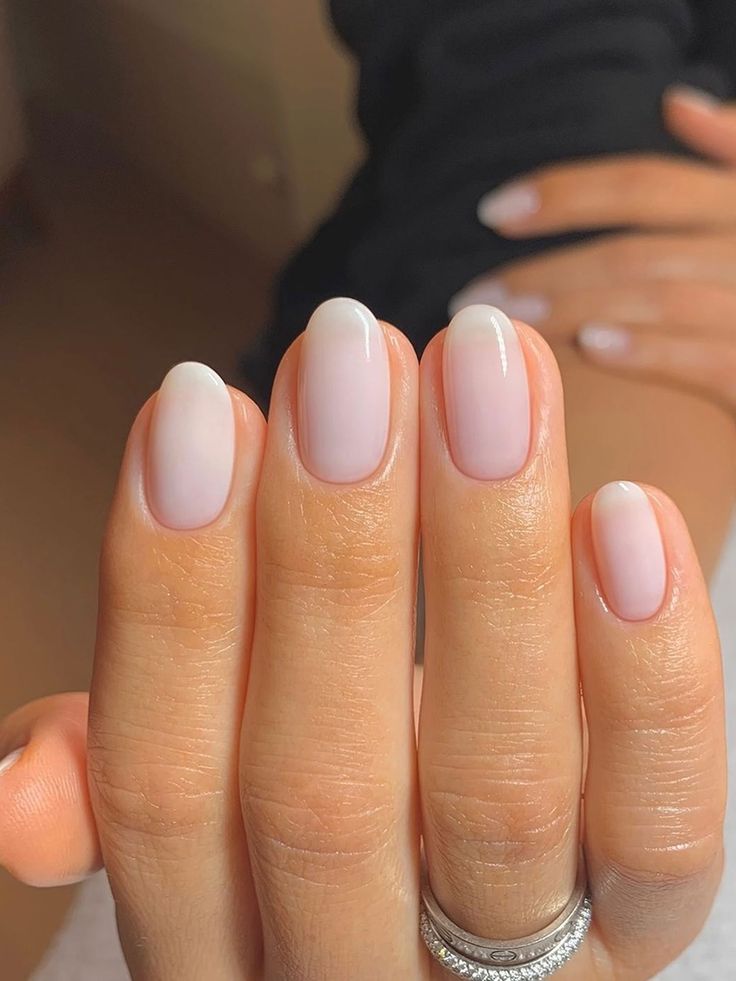 Sophisticated Ombre Nail Design: Sheer Pink to Delicate White Tips.