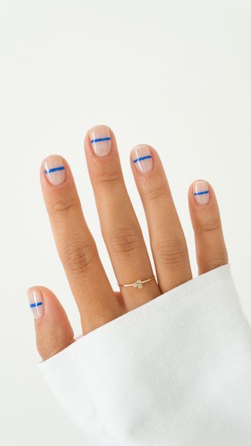 Elegant Geometric Nail Design: Minimalist Blue Stripes on a Clear Base