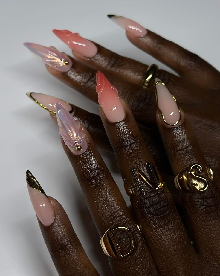 Sophisticated Soft Pink Gradient Nail Design with Leaf Accents and Gold Tips