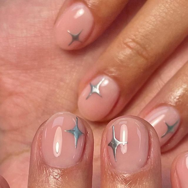 Elegant Soft Nude Nail Design with Sparkling Silver Star Accents