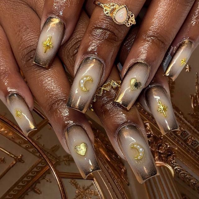 Sophisticated Coffin Nail Design: Soft Brown and Beige Gradient with Glamorous Gold Charms