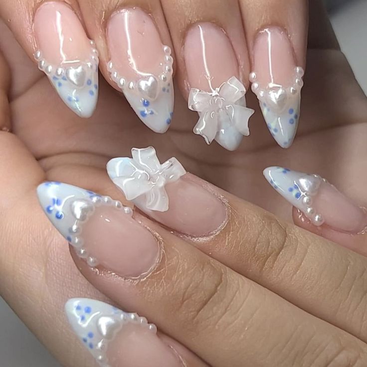 Elegant Almond-Shaped Nails with Pastel Florals, Pearls, and Charming Bows.