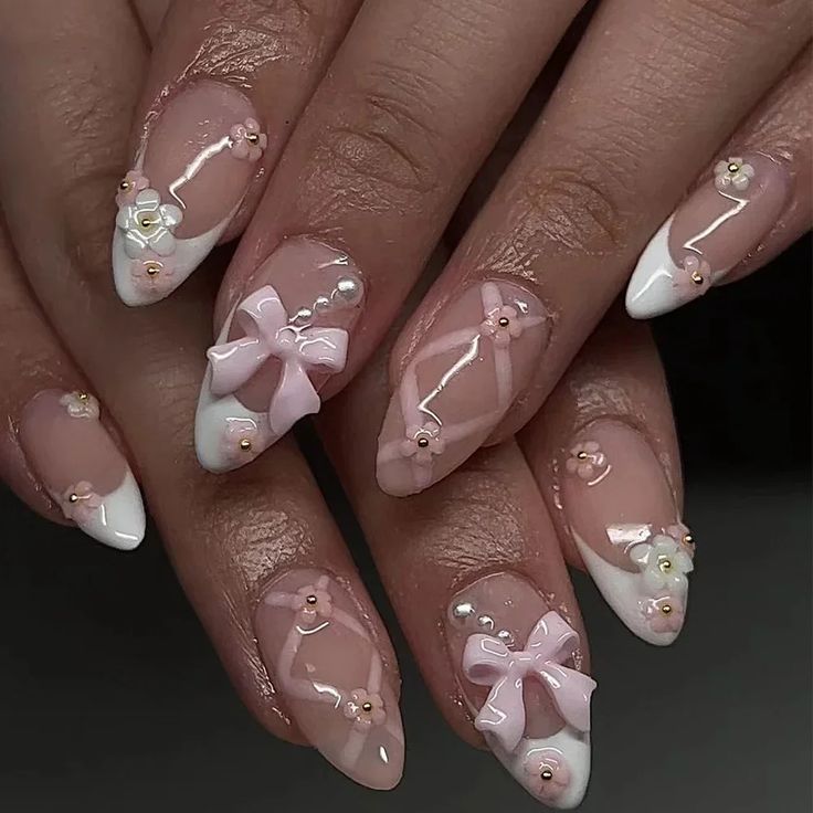 Chic Soft Pink and White Nail Design with Floral Embellishments and Glossy Finish.