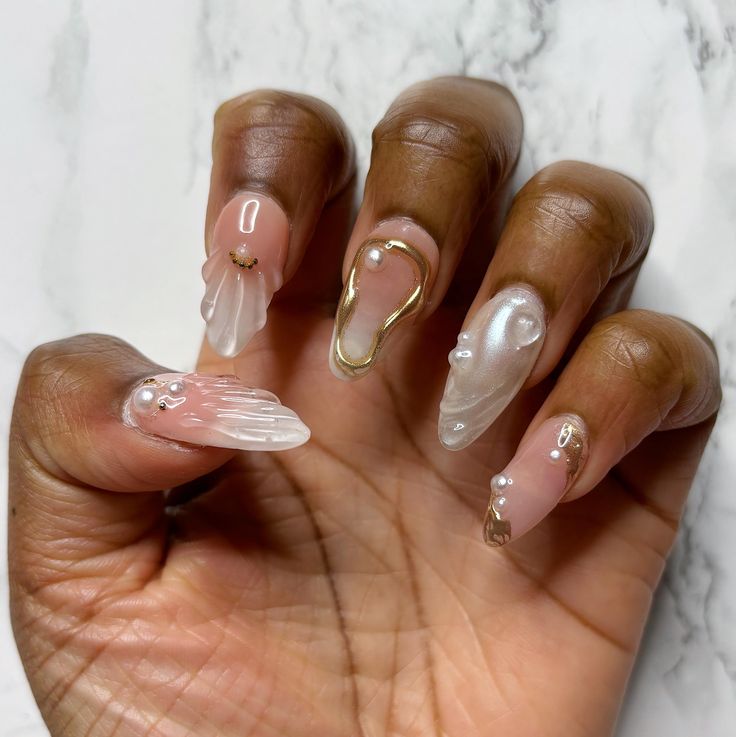 Sophisticated Nail Design with Soft Pinks, Translucent Finishes, and Unique Embellishments.