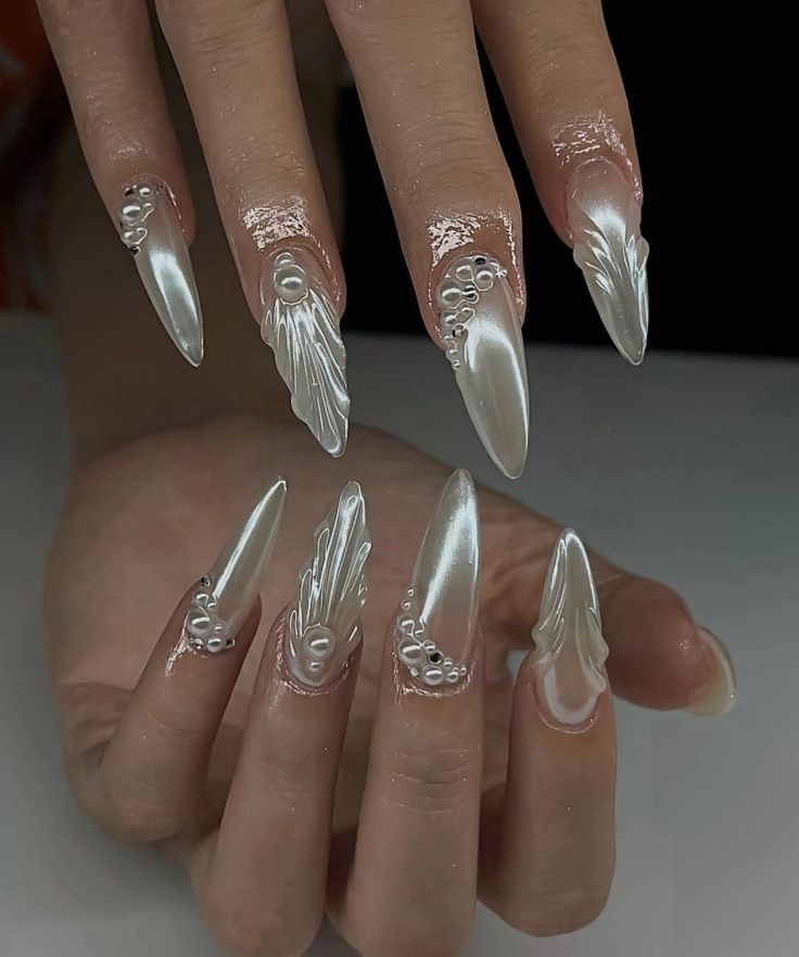 Sophisticated Pearlescent Stiletto Nail Design with Floral Embellishments.