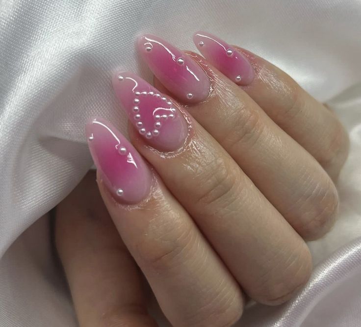 Charming Pink Ombre Nails with White Swirls and Pearl Accents for a Sophisticated Look.