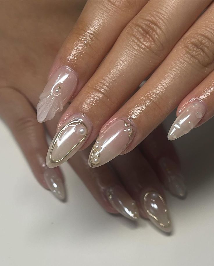 Sophisticated Elegant Almond Nail Design with Glossy Finish and Luxurious Embellishments.