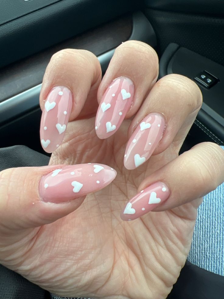 Charming Heart-Themed Pink Nail Design with Whimsical White Hearts and Polka Dots.