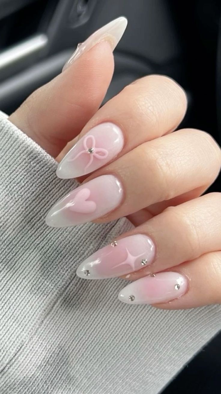 Elegant Chic Nail Design with Soft Pink Gradient, Heart Motifs, and Rhinestones.