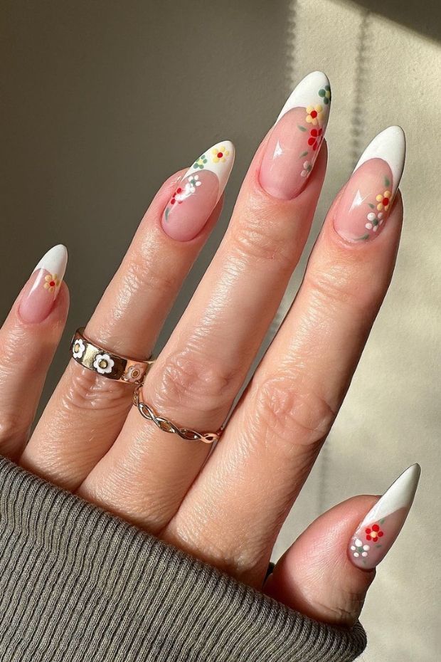 Elegant Floral Nail Design with White Tips and Chic Accessories.