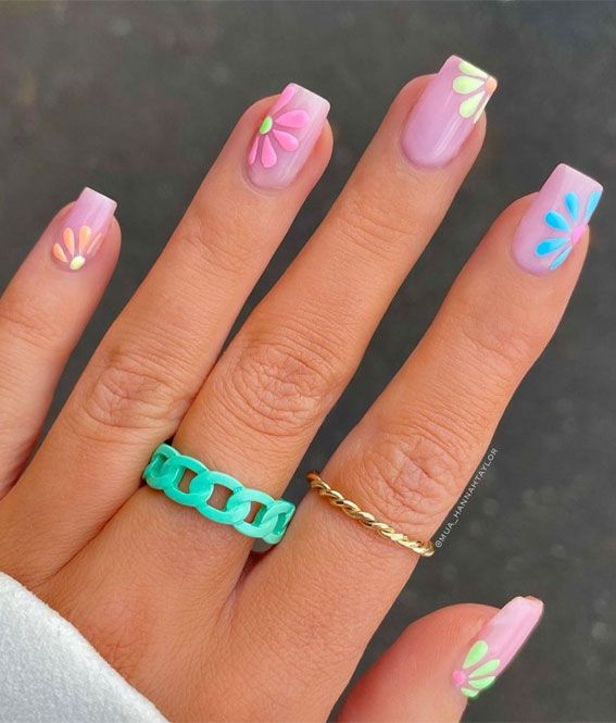 Whimsical Pastel Floral Manicure with Trendy Rings for a Fresh Look