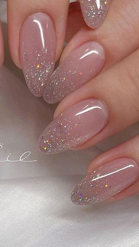 Glistening Ombre Nails with Sparkly Glitter for Elegant, Playful Glamour.