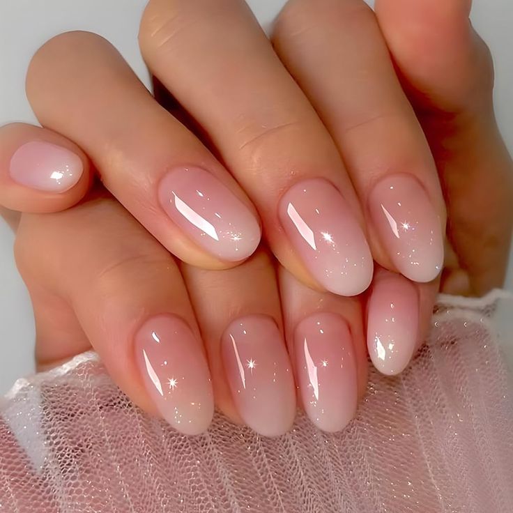 Elegant Glittering Ombre Nails: A Subtle Pink Gradient with Translucent Tips for Timeless Beauty.