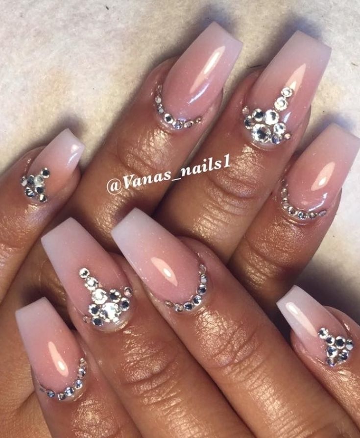 Sophisticated Soft Pink Ombre Nail Design with Artistic Rhinestone Accents.