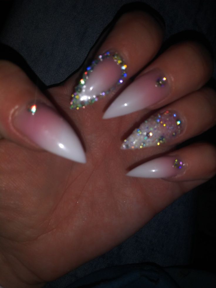 Glamorous Gradient Pink and White Nail Design with Glitter and Iridescent Gems.