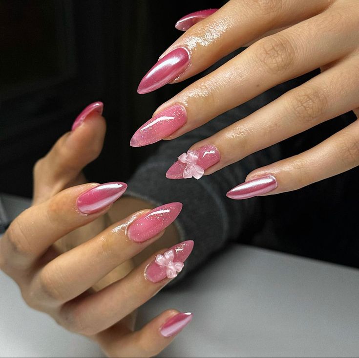 Elegant Pink Stiletto Nails: Striking Shine with Feminine Floral Embellishments.