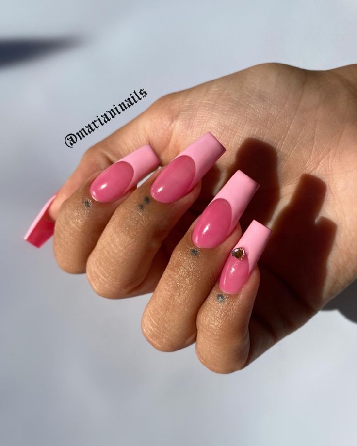 Elegant Pink Matte and Glossy Nail Design with Circular Negative Space and Gem Accents.