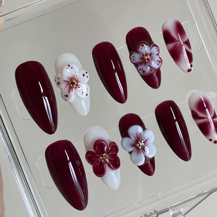 Sophisticated Burgundy Nail Design with Floral Accents and Mixed Finishes for Special Occasions