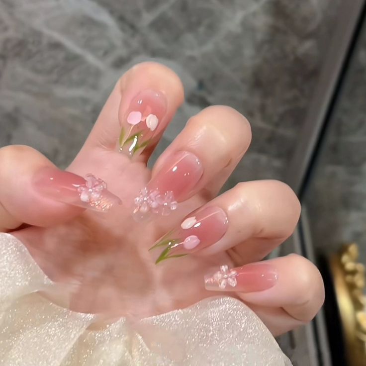 Delicate Floral Nail Design: Soft Pink and Green Elegance for Any Occasion.