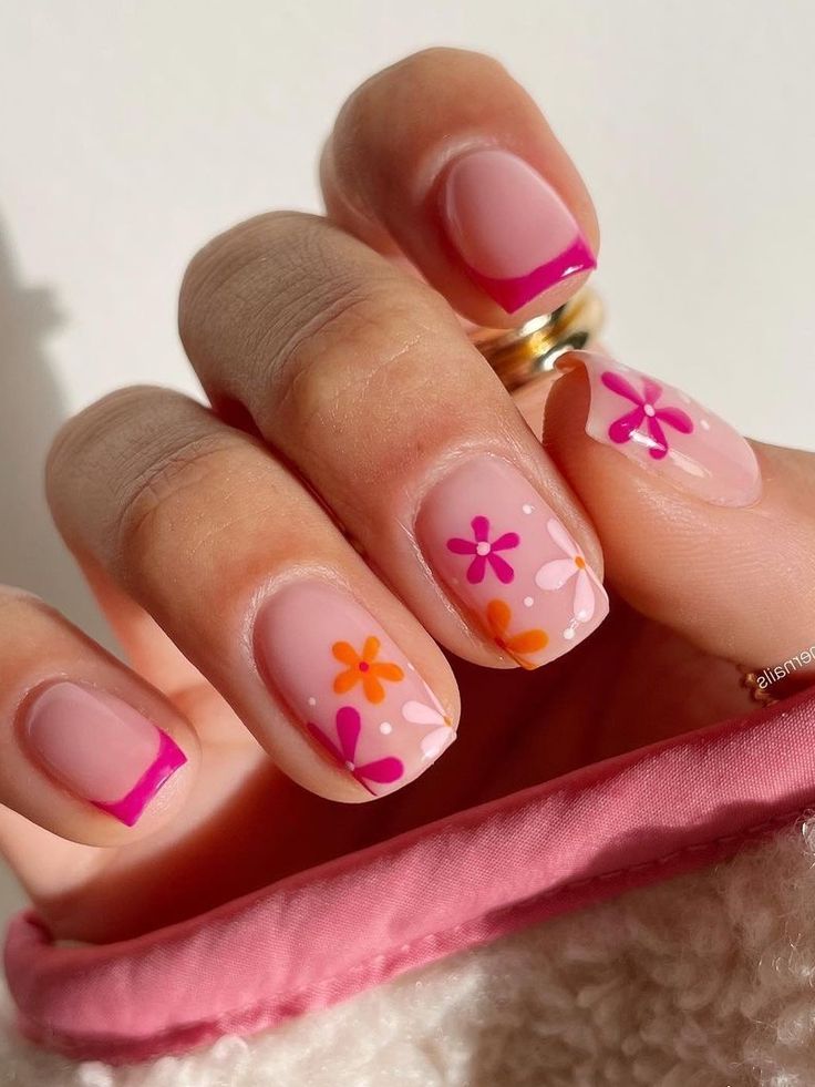 Vibrant Floral Nail Design: Playful Pink and Orange Flowers with Trendy Fuchsia Tips for Spring/Summer Elegance.