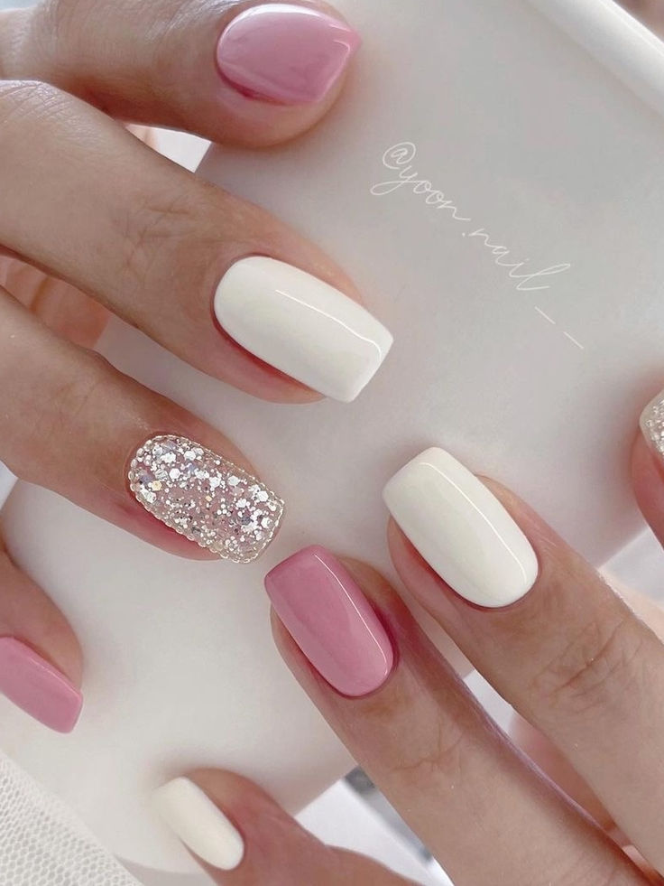 Elegant Playful Nail Design: Soft Pink, Crisp White, and Iridescent Gems.