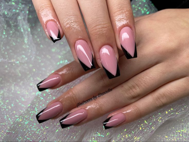 Chic Pink and Black Geometric Nail Design: A Stylish Statement with Feminine Elegance.