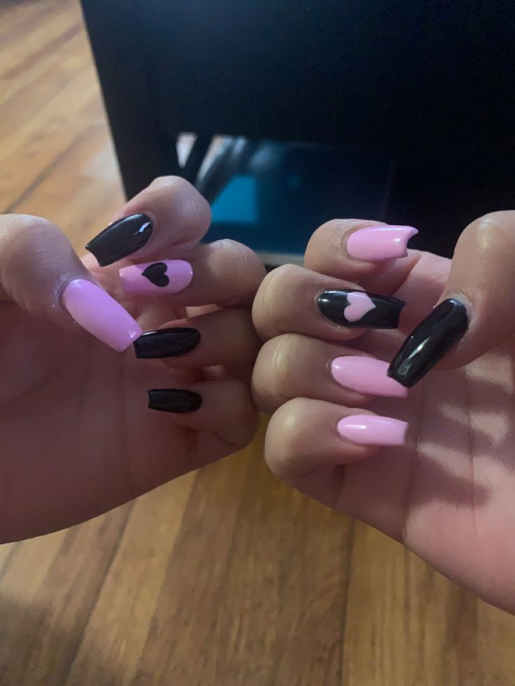 Playful Pink and Black Heart-Inspired Nail Design for a Trendy Aesthetic.