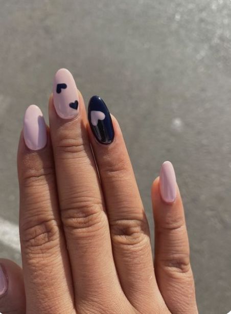 Whimsical Heart-Themed Nail Design in Soft Pink and Deep Navy Combining Elegance and Fun