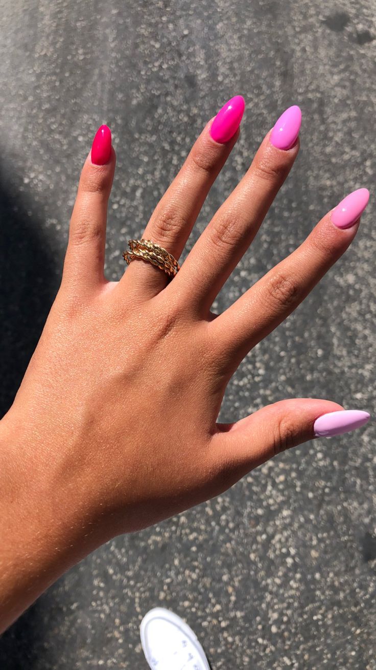 Bold Pink and Magenta Nail Design with Elongated Oval Shape and Gold Accents.