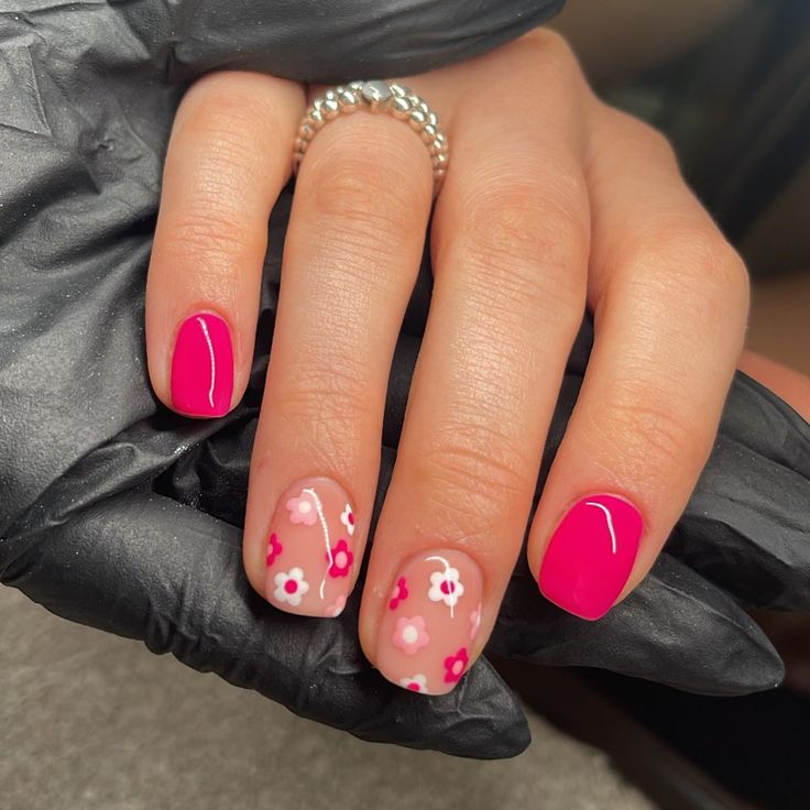 Bold Pink and Pastel Floral Nail Design: A Trendy Aesthetic.