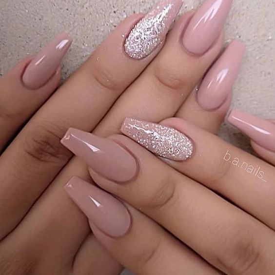 Chic Oval Nail Design: Soft Nude Base with Sparkling Silver Accents