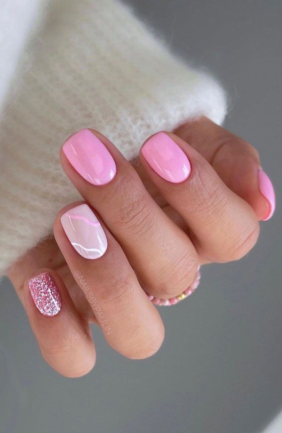 Chic Soft Pink Nail Design with Marble Effect and Glitter Accents