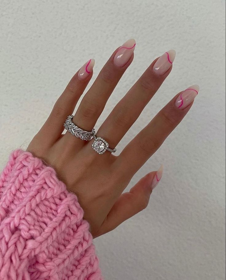 Chic Modern French Manicure: Nude Base with Bold Pink Tips and Glam Accessories.