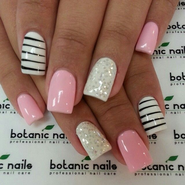 Chic Nail Design: Soft Pink with Striking Black Stripes and Glamorous Glitter Accents.