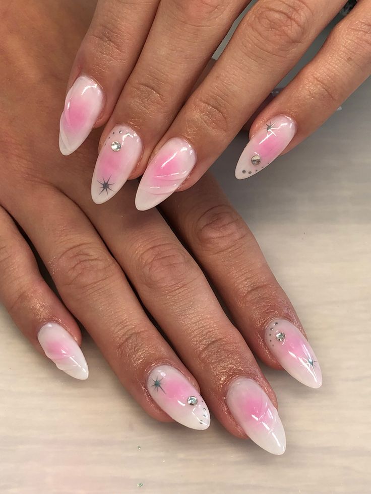 Elegant Ombre Nail Design with Pink-White Gradient, Silver Stars, and Sparkling Rhinestones.