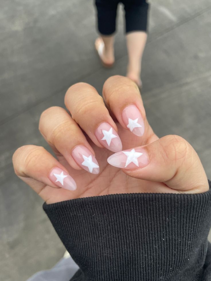 Elegant Soft Pink Ombre Nails with Playful White Star Designs