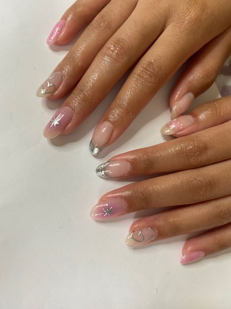 Sophisticated Pastel Nail Design with Silver Tips and Whimsical Embellishments.