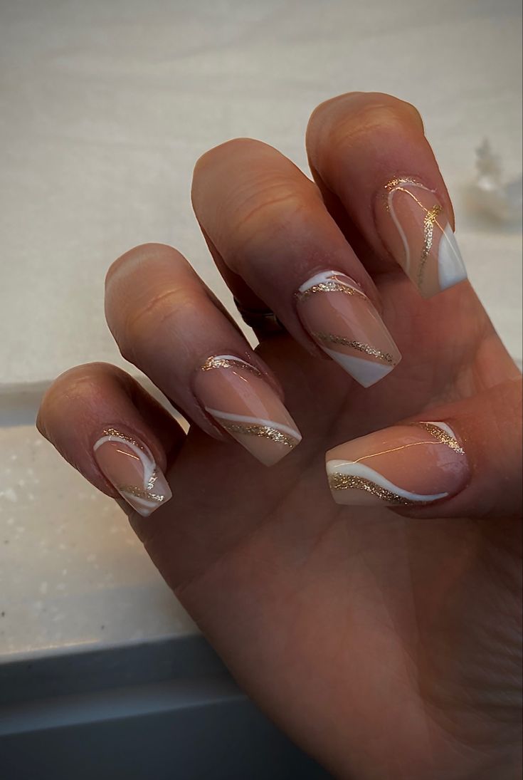 Sophisticated Nail Design: Nude and White with Golden Lines and Asymmetrical Geometry.