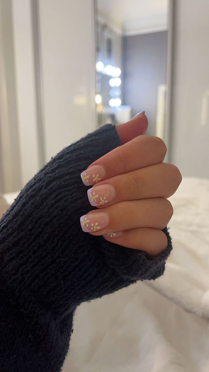 Elegant Nude French Tip Manicure with Dainty Yellow Flower Accents