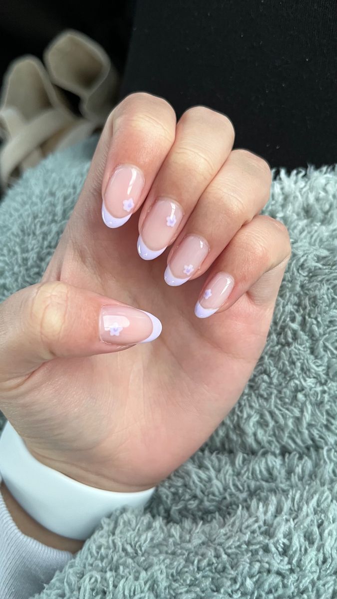 Charming Soft Lavender French Manicure with Floral Accents.