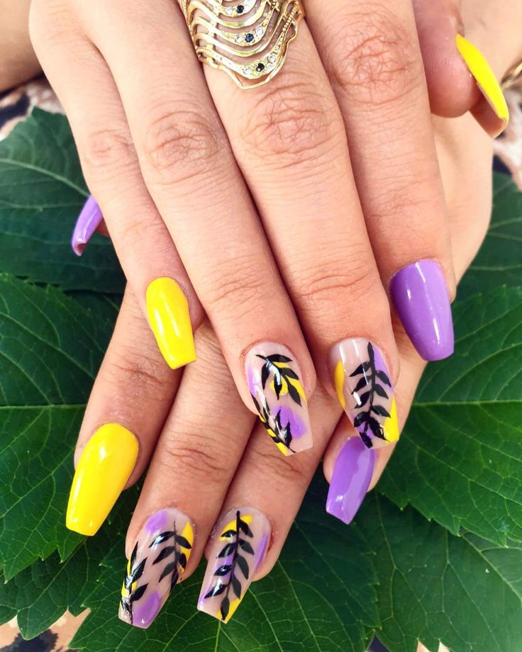 Vibrant Purple and Yellow Nail Design with Intricate Leaf Patterns and Glossy Finish.