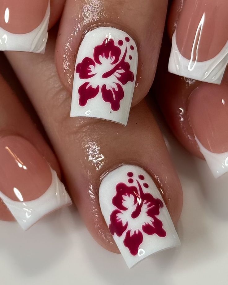 Chic Summer Floral Nail Art: Burgundy Hibiscus on a Glossy White French Tip Base.