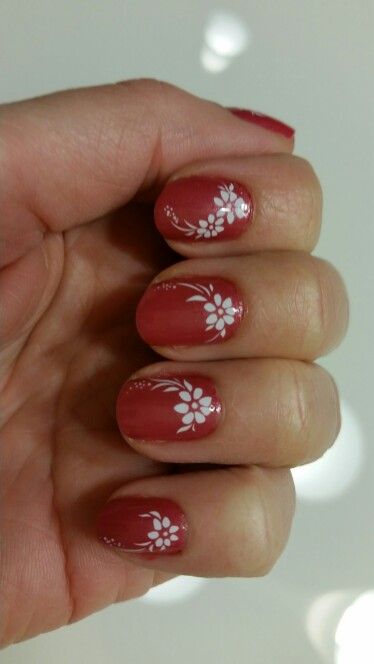 Charming Floral Nail Design with Reddish-Brown Base and White Motifs