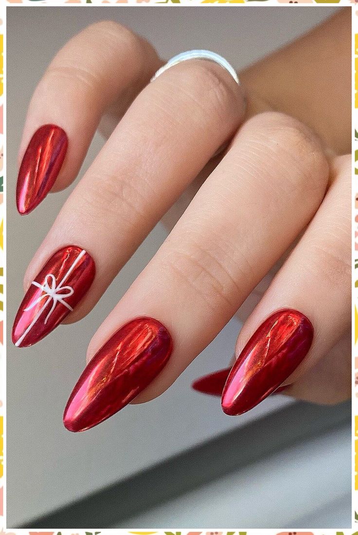 Glamorous Shimmering Red Nail Design with Metallic Finish and Whimsical Bow Accent