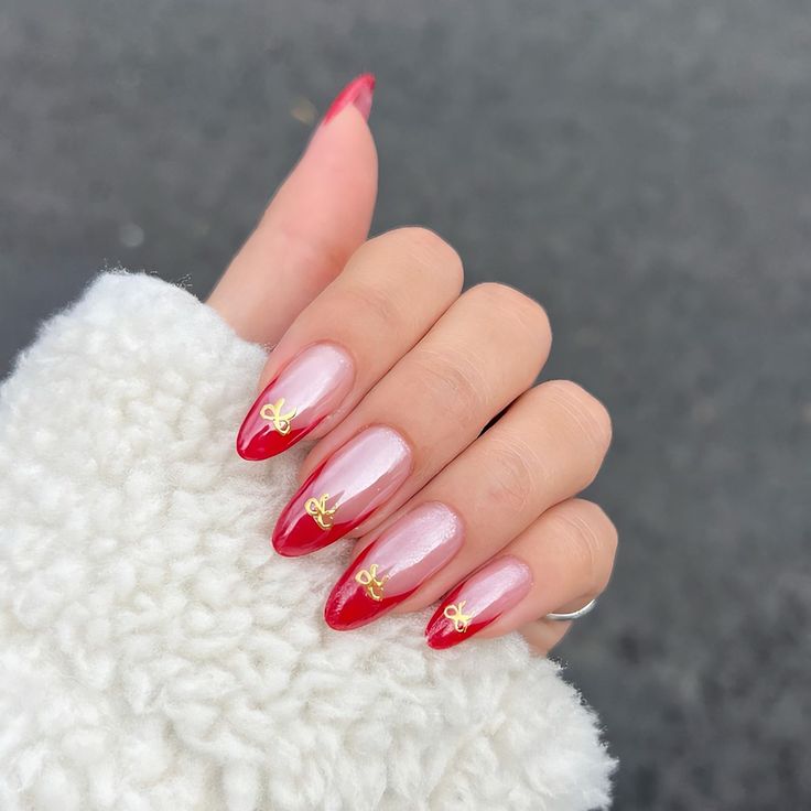 Chic Nail Design: Bold Red Tips with Soft Pink and Elegant Gold Embellishments