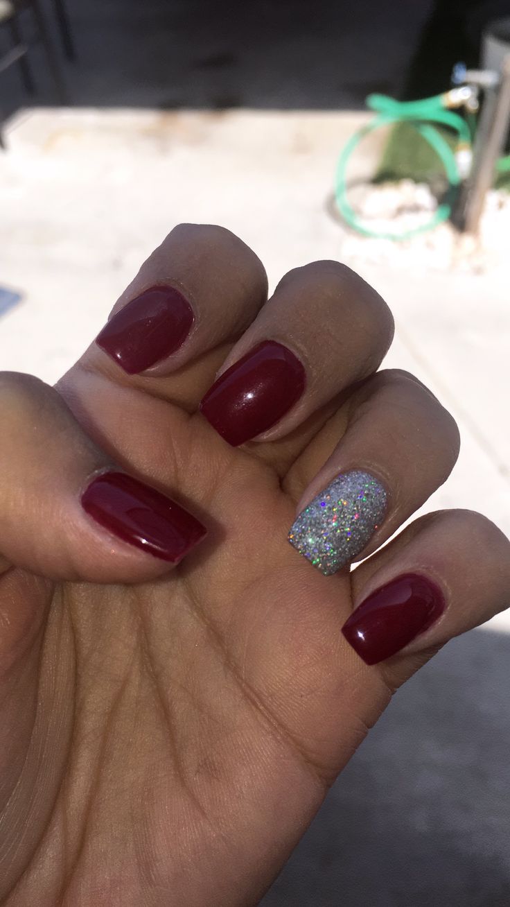 Sophisticated Deep Burgundy Nail Design with Sparkling Silver Accent.