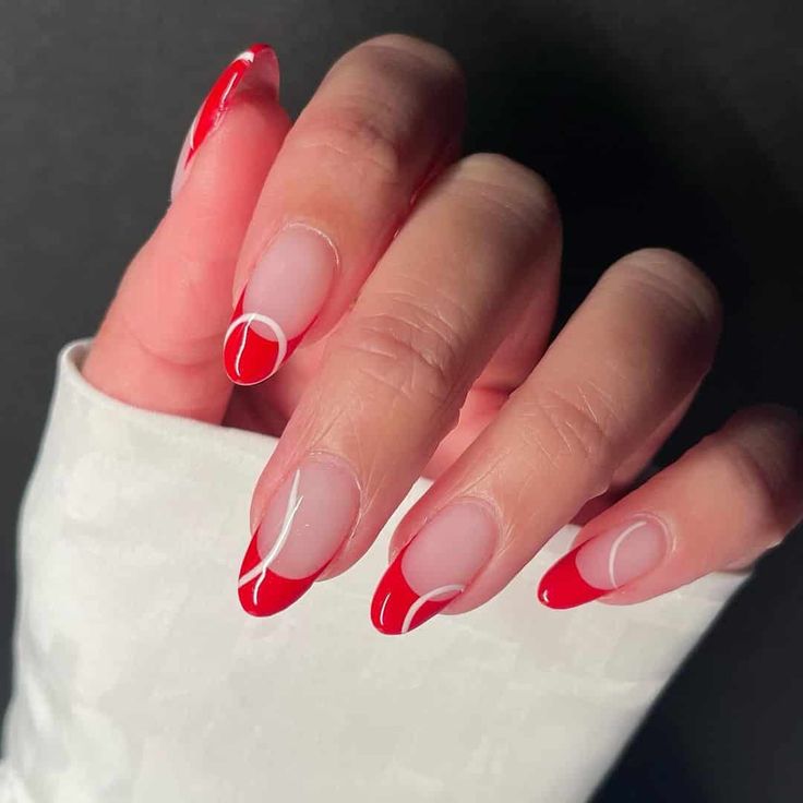 Sophisticated Nail Design: Bold Red Tips with Delicate White Accents for a Modern Chic Look.