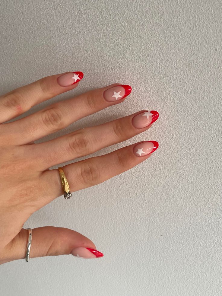 Chic French Tip Nail Design with Vibrant Red and Playful Star Accents.