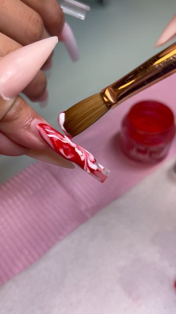 Dynamic Red and White Marble Nail Design for a Striking Manicure.